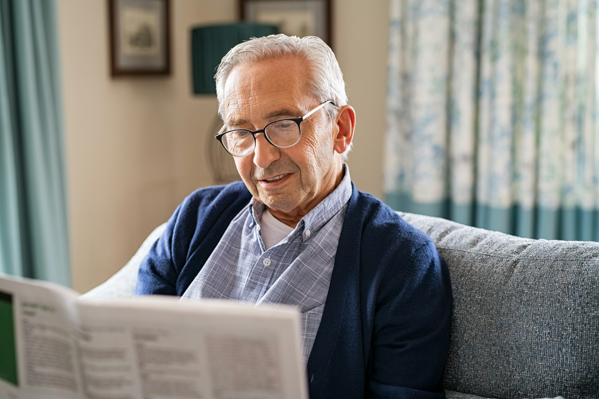 Old man reading newspaper